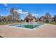 Community pool with clear water and a quaint pool house in a well-maintained residential area at 2824 W Centennial Dr # L, Littleton, CO 80123