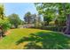 Expansive backyard featuring lush green grass, mature trees, and manicured landscaping offering a serene outdoor space at 7858 Oban Ct, Lone Tree, CO 80124