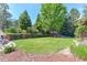Expansive backyard showcasing a lush green lawn, mature trees, and serene landscaping at 7858 Oban Ct, Lone Tree, CO 80124