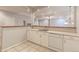 Basement bar area with white cabinets, a sink, and a dishwasher at 7858 Oban Ct, Lone Tree, CO 80124