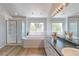 Bright bathroom with double sinks, a soaking tub, and a separate glass shower at 7858 Oban Ct, Lone Tree, CO 80124