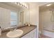 Bathroom featuring modern fixtures, a vanity with a sink, and a shower/tub combo at 7858 Oban Ct, Lone Tree, CO 80124