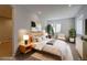 Bright bedroom with a modern bed frame, neutral decor, and a cozy sitting area at 7858 Oban Ct, Lone Tree, CO 80124