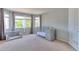 Bright Bedroom with large windows, a crib, and a cozy seating area at 7858 Oban Ct, Lone Tree, CO 80124