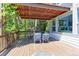 Relaxing outdoor deck featuring a dining table and chairs beneath a pergola at 7858 Oban Ct, Lone Tree, CO 80124