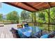 Inviting outdoor deck with a dining table, chairs, and lush vine-covered pergola at 7858 Oban Ct, Lone Tree, CO 80124