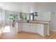 Bright kitchen features white cabinets, wood countertops, and scenic views from large windows at 7858 Oban Ct, Lone Tree, CO 80124