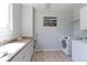 Bright laundry room offers a sink, cabinets, and modern washer and dryer at 7858 Oban Ct, Lone Tree, CO 80124