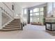 Bright and airy living room with soaring ceilings, large windows, and a cozy fireplace at 7858 Oban Ct, Lone Tree, CO 80124