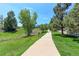 Scenic walking path winding through green spaces and trees, providing a peaceful and inviting outdoor experience at 7858 Oban Ct, Lone Tree, CO 80124