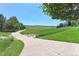 Picturesque walking path surrounded by green hills and mature trees, offering a serene and inviting outdoor experience at 7858 Oban Ct, Lone Tree, CO 80124