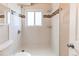Bright bathroom featuring tiled shower with glass tile accents at 261 Linda Ln, Denver, CO 80221