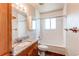 Bathroom vanity with wood cabinets, granite counters, and a shower/tub combo at 261 Linda Ln, Denver, CO 80221