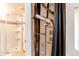Bathroom with a glass shower, tile surround, and updated fixtures; furnace is adjacent at 261 Linda Ln, Denver, CO 80221