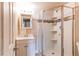 Bathroom featuring a new vanity and tiled shower with glass door at 261 Linda Ln, Denver, CO 80221
