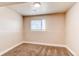 Clean bedroom featuring a window and neutral paint, carpet, and lighting at 261 Linda Ln, Denver, CO 80221