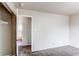 Spacious bedroom featuring neutral paint, carpet, and an adjacent closet with open doorway at 261 Linda Ln, Denver, CO 80221