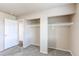 Bedroom featuring closet, neutral walls, and bright light from adjacent door at 261 Linda Ln, Denver, CO 80221