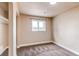 Cozy bedroom with neutral paint, carpet, and a window providing natural light at 261 Linda Ln, Denver, CO 80221