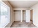 Bedroom with carpet flooring, a closet, and a large window with neutral paint at 261 Linda Ln, Denver, CO 80221