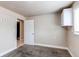 Bedroom featuring neutral paint, carpet, storage, and entry to bathroom at 261 Linda Ln, Denver, CO 80221