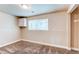 Bedroom with neutral paint, plush carpet, and bright natural light from the window at 261 Linda Ln, Denver, CO 80221