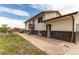 Exterior of the home with a walkout door, showing the yard, siding, and brick foundation at 261 Linda Ln, Denver, CO 80221