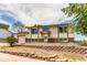 Charming home exterior with a retaining wall, lush landscaping, and an inviting front entrance at 261 Linda Ln, Denver, CO 80221