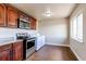 Functional laundry area with modern appliances and tiled floors at 261 Linda Ln, Denver, CO 80221