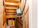 Basement stairway with exposed wood and a surveillance monitor on a small shelf at 261 Linda Ln, Denver, CO 80221