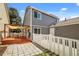 View of backyard including patio, deck and privacy fence at 4713 Perth St, Denver, CO 80249