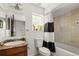 Bathroom with a shower-tub combo and a dark wood vanity at 4713 Perth St, Denver, CO 80249