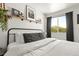 Bright bedroom features a metal bed frame, floating shelves and an outdoor view at 4713 Perth St, Denver, CO 80249