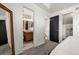 View from bedroom into bathroom; door to stairwell with carpet at 4713 Perth St, Denver, CO 80249