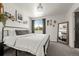 The bedroom has neutral walls, carpet, and a black metal frame bed at 4713 Perth St, Denver, CO 80249