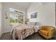 Cozy bedroom with vaulted ceiling, large window, and comfortable seating area at 4713 Perth St, Denver, CO 80249