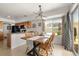Dining area with a modern light fixture, wooden table set and backyard views at 4713 Perth St, Denver, CO 80249