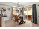 Bright dining room features modern chandelier and sliding doors to outdoor patio with a hot tub at 4713 Perth St, Denver, CO 80249