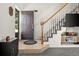 Inviting entryway boasts tile flooring, a staircase with white spindles, and access to the main living areas at 4713 Perth St, Denver, CO 80249