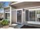 Close-up of a tan house with front door and window and well-maintained lawn and garden at 4713 Perth St, Denver, CO 80249