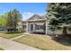 Charming home featuring mature trees, a well-kept lawn, and inviting front entrance at 4713 Perth St, Denver, CO 80249
