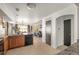 Open-concept kitchen, dining, and living space boasts lots of natural light and tile floors at 4713 Perth St, Denver, CO 80249