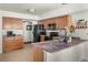 Open kitchen features granite countertops, stainless steel sink, and modern black appliances at 4713 Perth St, Denver, CO 80249