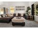 Stylish living room features a cozy sectional sofa, unique wall art, and ample natural light at 4713 Perth St, Denver, CO 80249