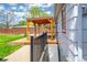 Side view of backyard deck and pergola; access point to the basement with iron railing at 1035 Quartz St, Golden, CO 80401