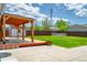 Spacious backyard boasting a covered patio, concrete pad, and lush lawn, ideal for relaxation and entertainment at 1035 Quartz St, Golden, CO 80401