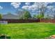 Large, lush green backyard with a tall fence and mature trees offering privacy at 1035 Quartz St, Golden, CO 80401