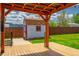 Inviting backyard featuring a wooden deck, shed, and well-maintained lawn, perfect for outdoor gatherings at 1035 Quartz St, Golden, CO 80401