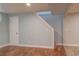 Bright basement featuring blue walls, white trim, wood-look floors, and carpet on the stairs at 1035 Quartz St, Golden, CO 80401