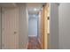 Finished basement hallway featuring hardwood floors, white doors, and a barn door to bathroom at 1035 Quartz St, Golden, CO 80401